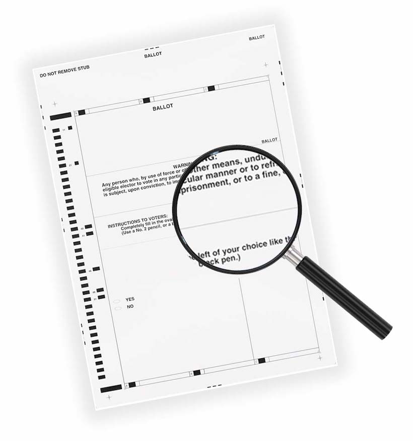 Magnifying glass over paper ballot